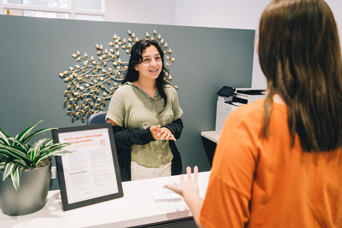 student being assisted at front desk