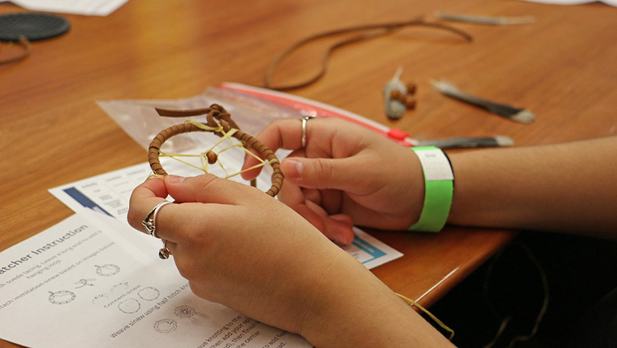 student making a dreamcatcher