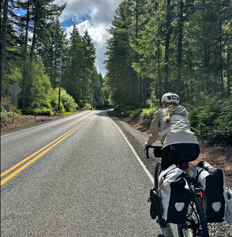 Glenn rides through Washington with her camping gear packed on her bike during the early days of the journey.