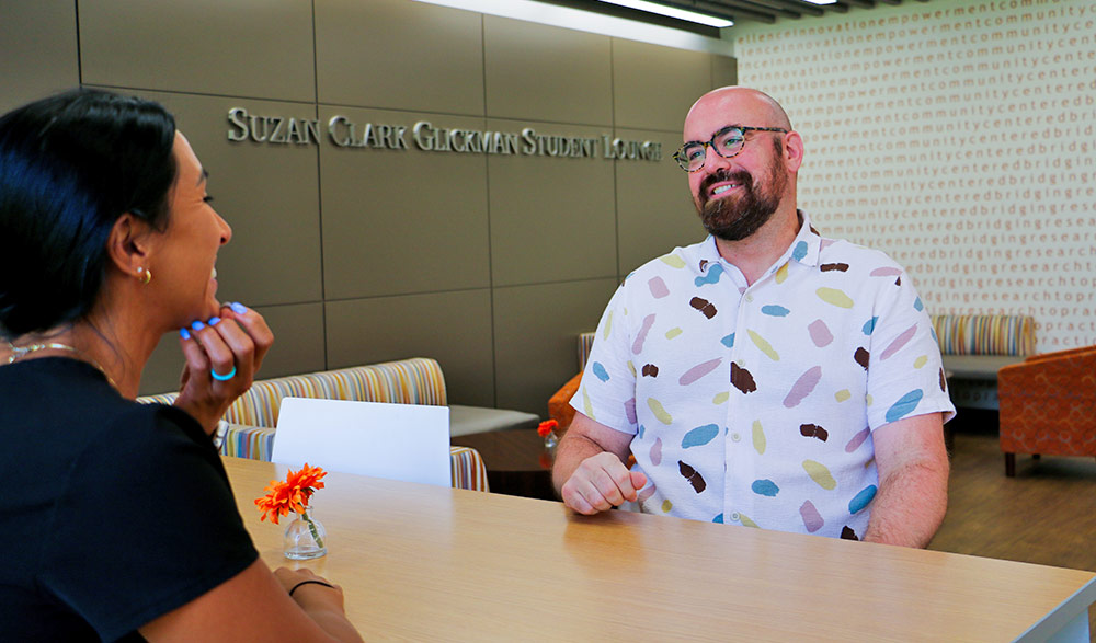 Michael Goodman, PhD meets with a student in the College of Education